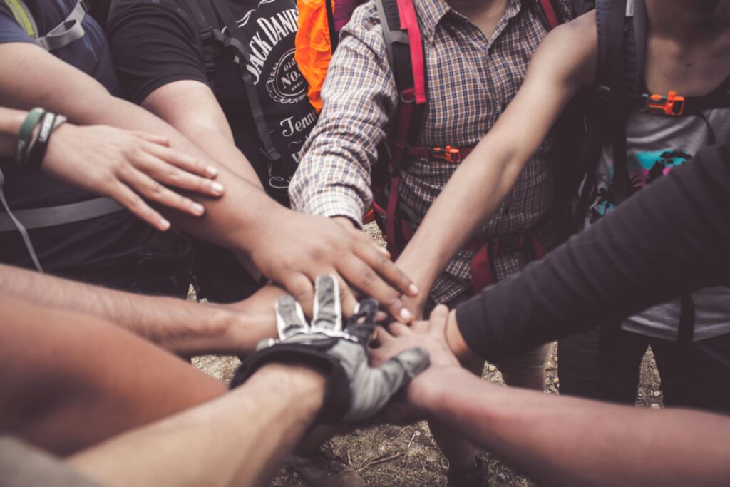 A ground of lots of different hands coming together in the centre.